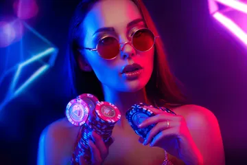 A woman smiling by bright slot machines showing lucky symbols, showcasing the exciting slot offerings at 456BDBET.